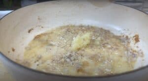 Sautéing garlic and onion in a pan, perfect start for a flavorful dish.