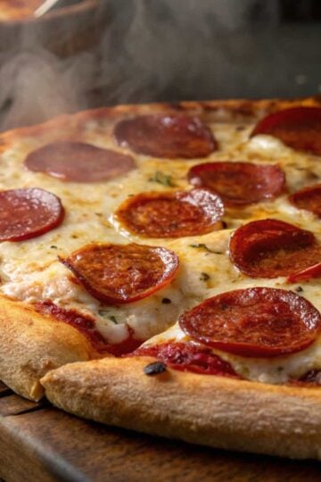 Steaming pepperoni pizza with melted cheese and crispy crust on a wooden board. Perfect for pizza lovers.
