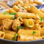 Creamy rigatoni pasta with fresh parsley and tender chicken, served in a bowl for a delicious, comforting meal.