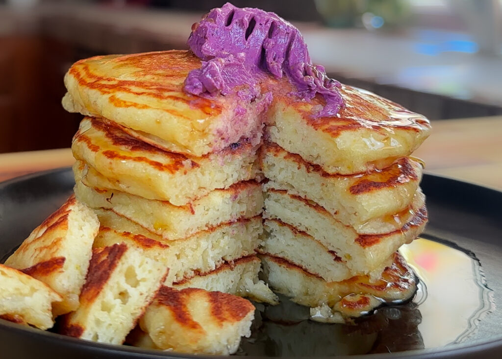 inside the lemon ricotta blueberry pancakes that shows how fluffy and thick they are.