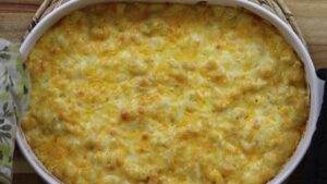 Cheesy baked macaroni and cheese in a white casserole dish, fresh from the oven and golden brown.