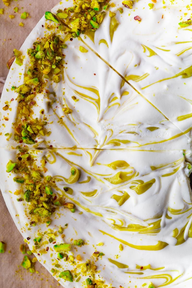 No-bake pistachio mascarpone cheesecake  and pistachio garnish, top view.