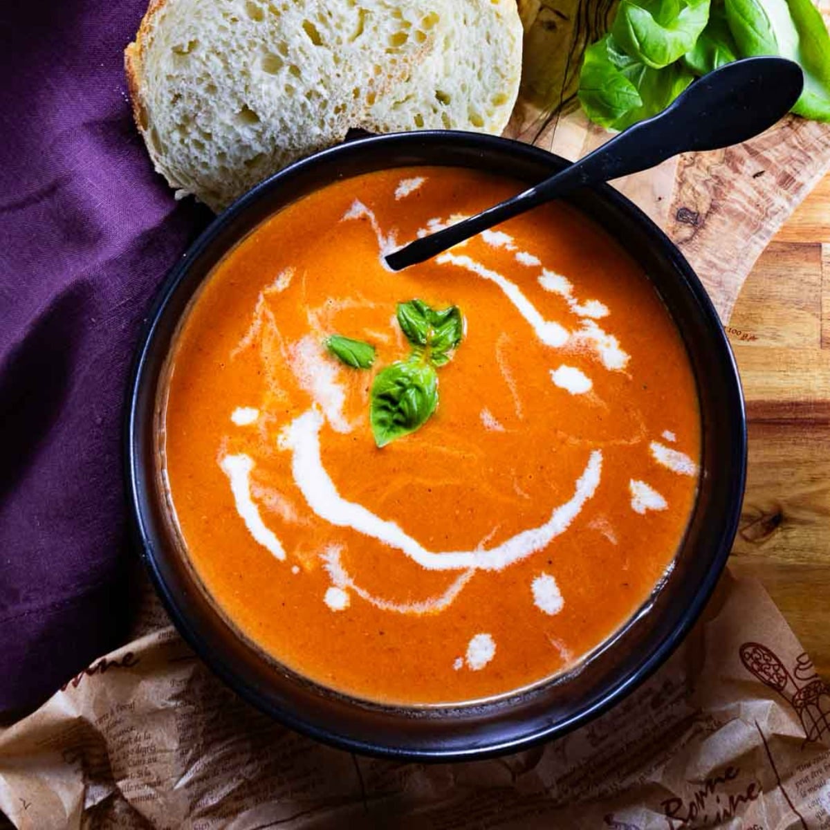 tomato soup in a black bowl