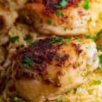 Greek Chicken Orzo Bake garnished with fresh parsley.