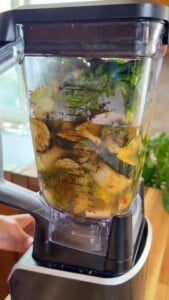 Close-up of a blender jar filled with vegetables.