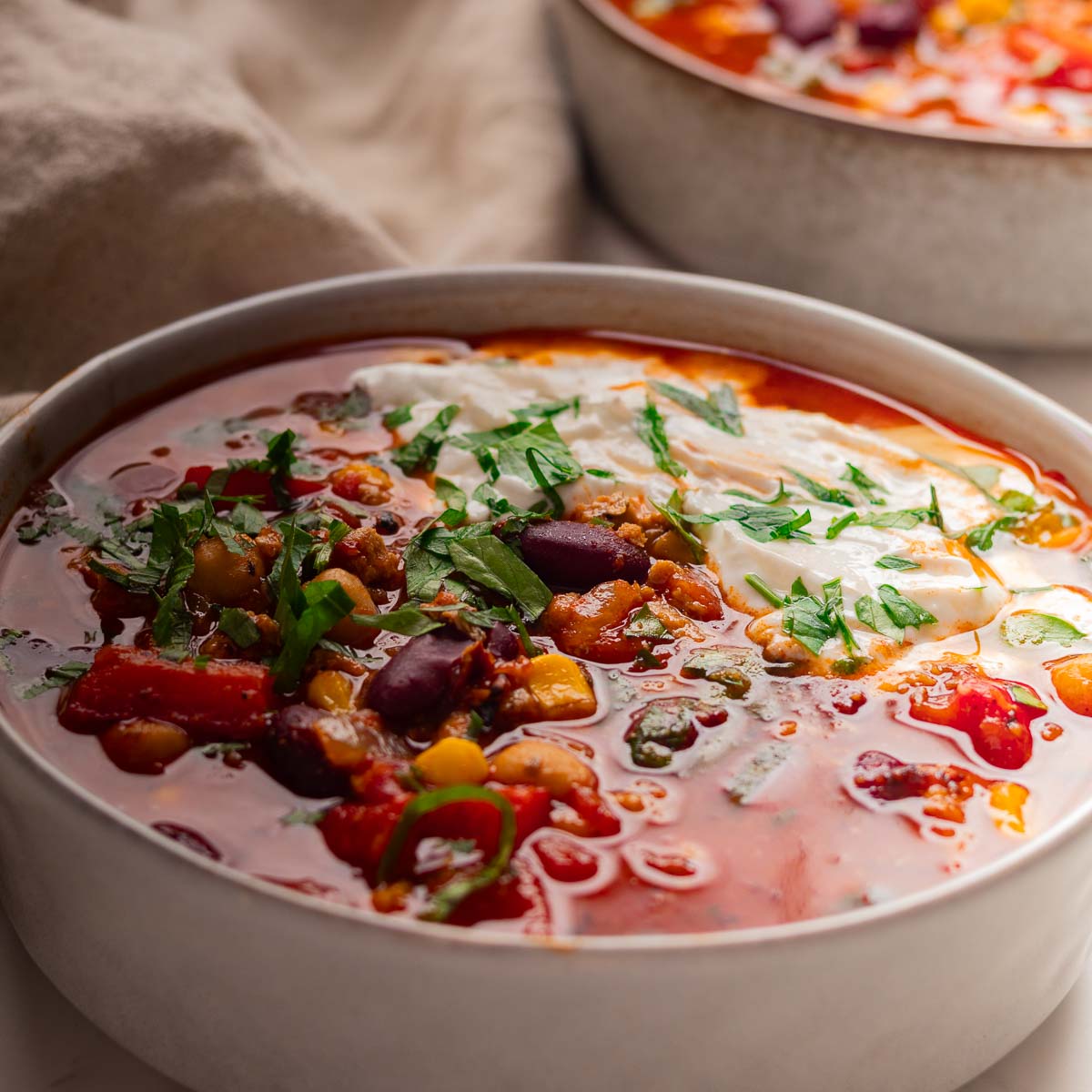 Chilli with beans, chickpeas in a white bowl