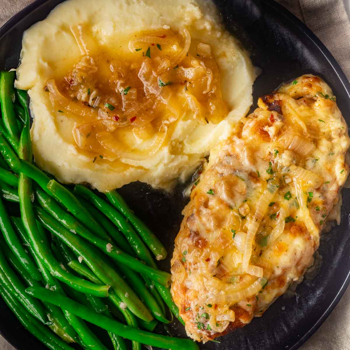 chicken, mashed potatoes and beans with sauce