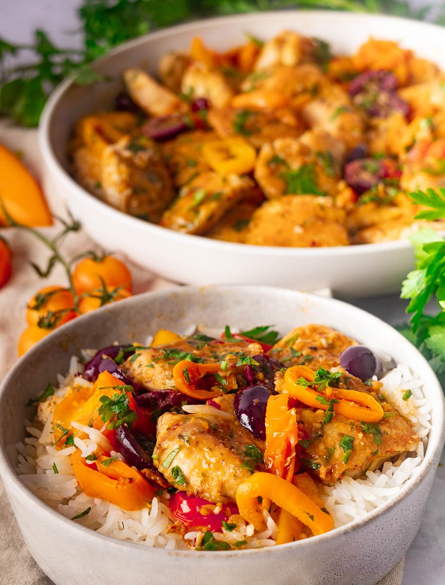 Mediterranean chicken and peppers garnished with herbs.