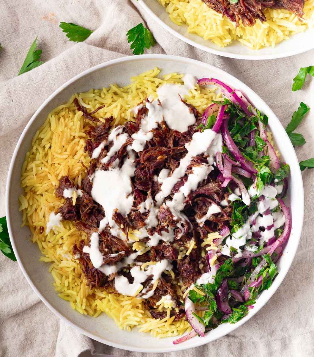 Spiced braised chuck roast, white sauce, and a side of red onion and parsley salad.