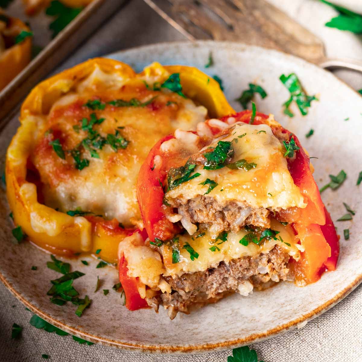2 round stuffed bellpeppers covered with cheese
