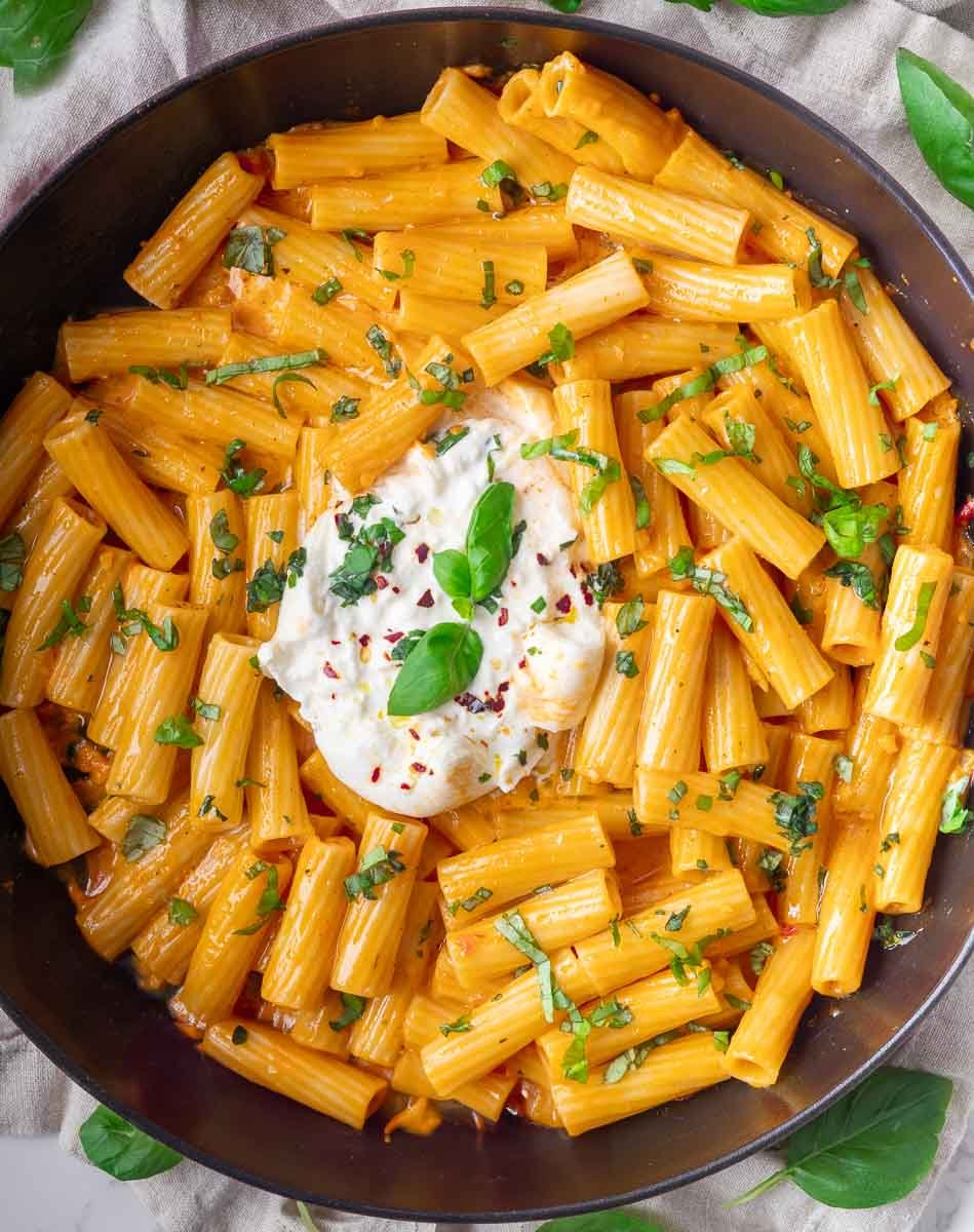 Delicious spicy burrata pasta with fresh herbs and creamy cheese.