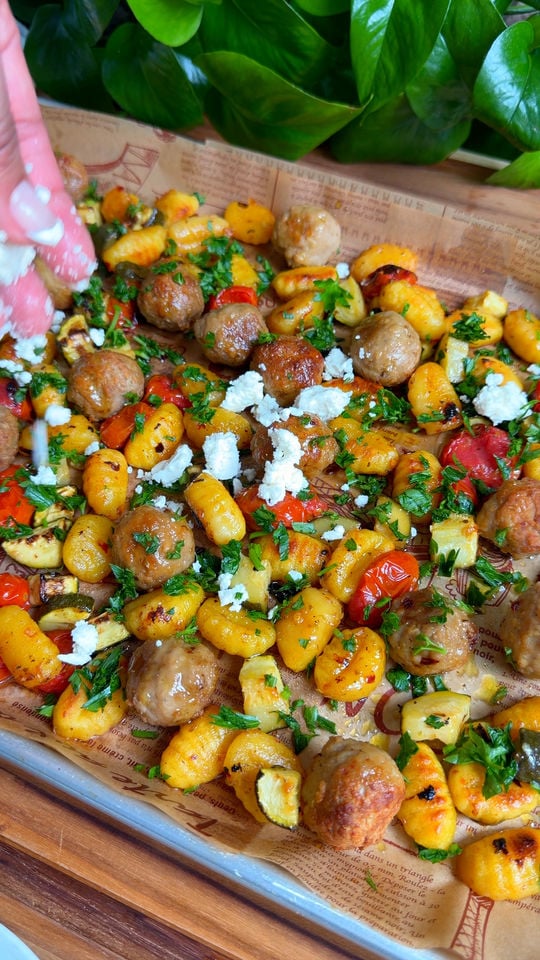 Roasted gnocchi with meatballs, zucchini, cherry tomatoes, feta, and herbs.
