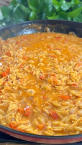 Creamy orzo pasta cooking.