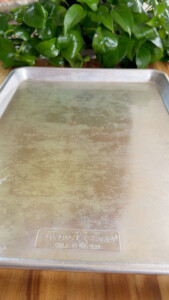Metal baking sheet with oil on it.