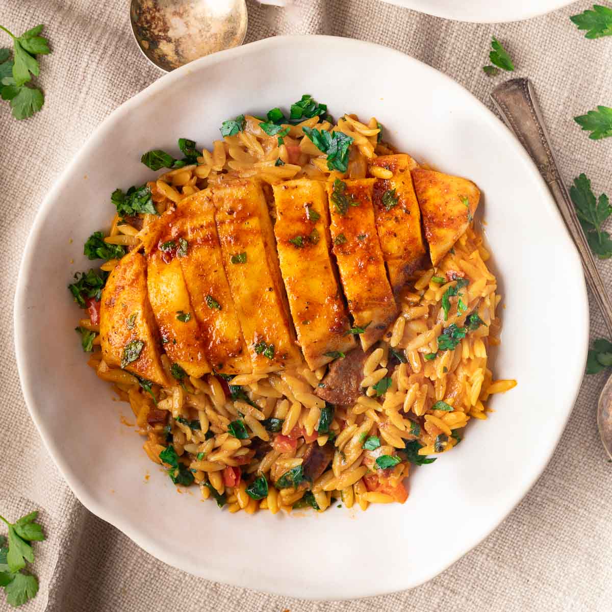 sliced chicken over creamy orzo
