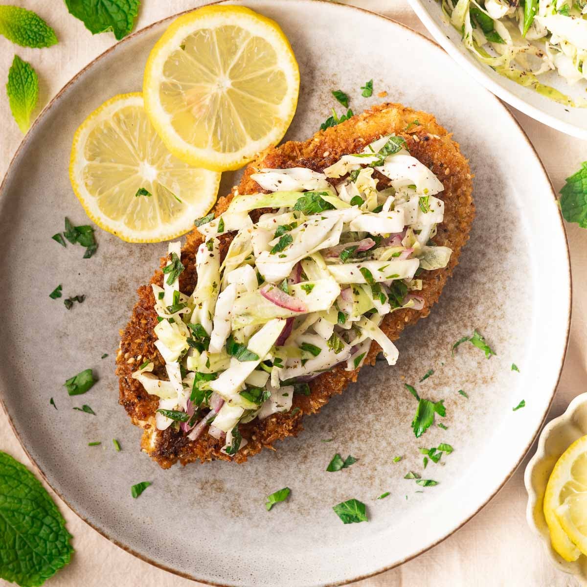 chicken cutlets with cabbage salad on top