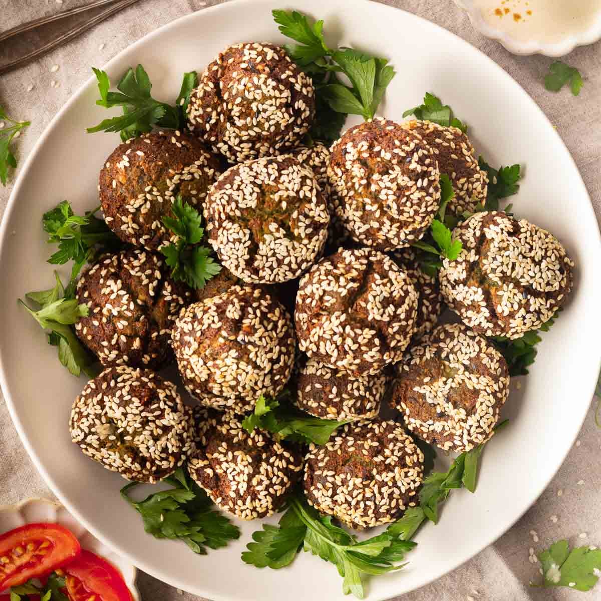 Plate of crispy homemade falafel balls garnished with fresh parsley.