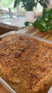 Freshly baked apple crumble pie pancakes on a wooden countertop.