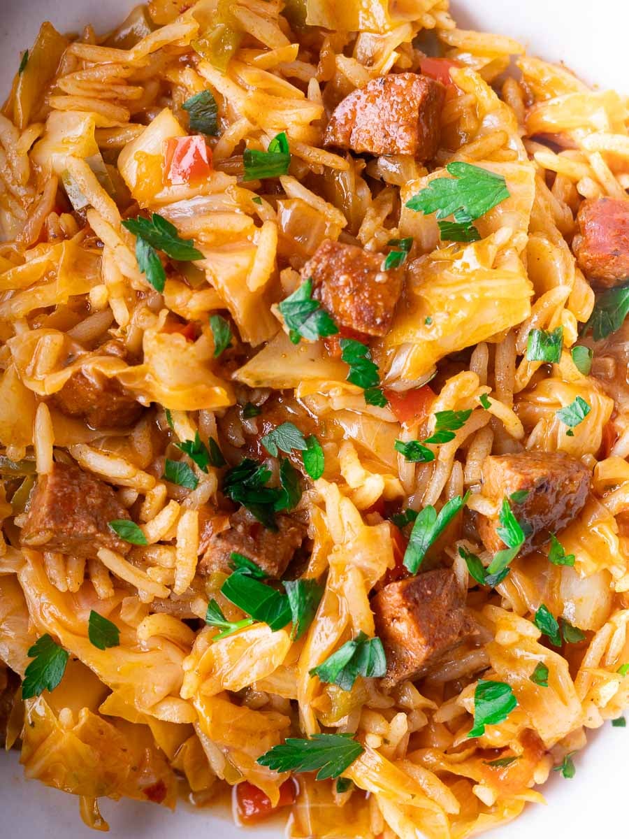 Mediterranean Dirty Cabbage with bell peppers, rice, and parsley garnished on top for a hearty meal.