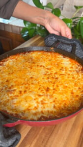 Baked cheesy gnocchi parm in a red cast iron skillet
