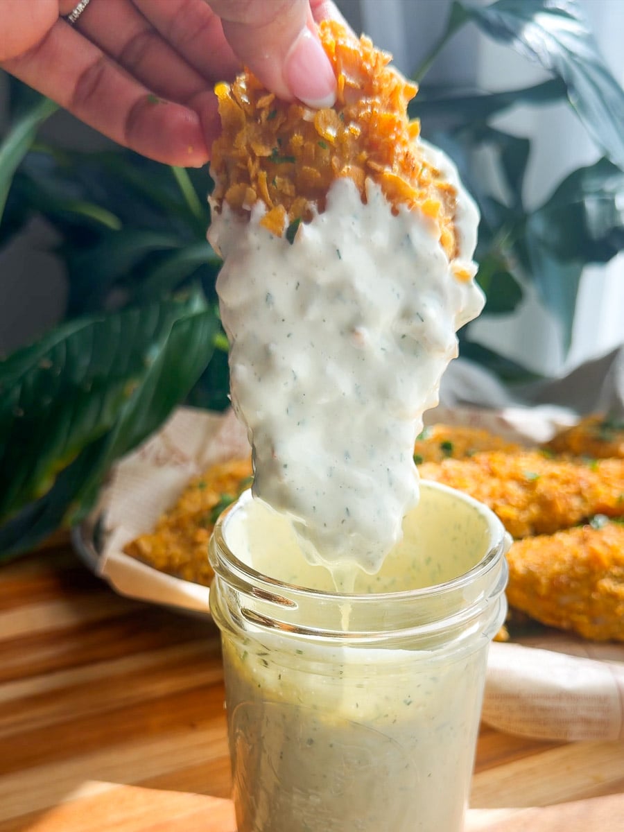 Crispy baked chicken tenders dipped in creamy herb sauce