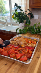 Roasted tomatoes, onions, and peppers on a sheet pan