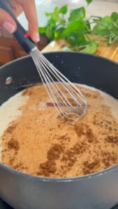 Whisking a pot of creamy spiced sahlab mixture